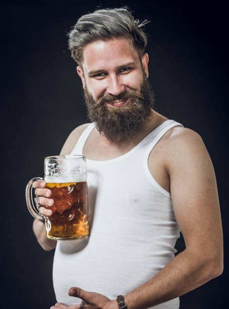 istock Young Man Holding a Glass of Beer 1144769801