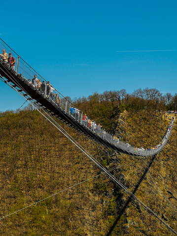 Moersdorf, Rhineland-Palatinate, Germany - April 22, 2019: many visitors on one of the longest suspension bridges in Europe