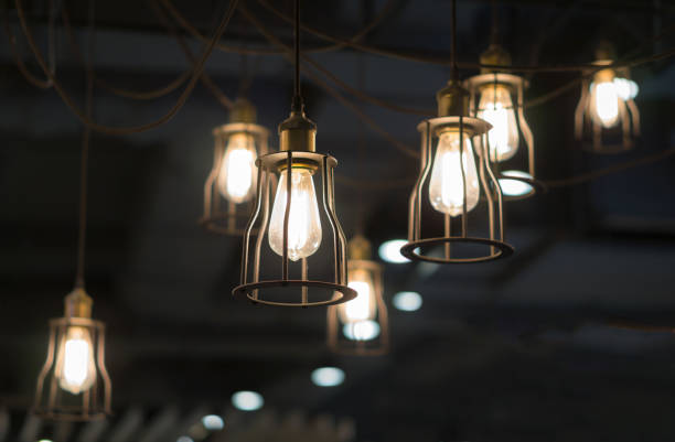 istock Low Angle View Of Illuminated Light Bulbs Hanging From Ceiling 1144770565