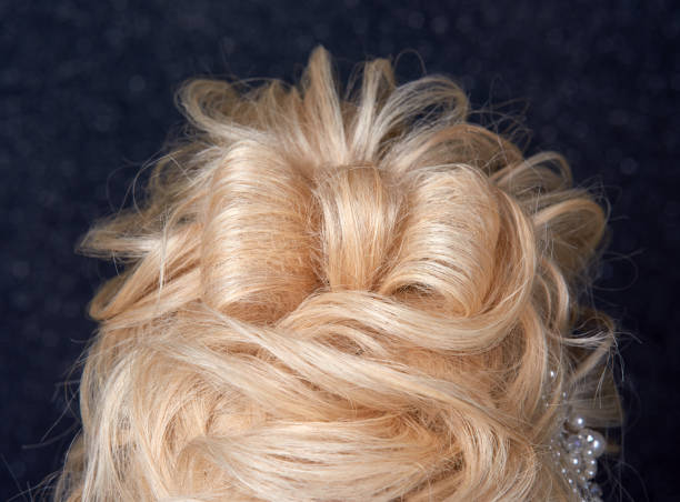 rear view of blond hair woman with hairbow, elegant hairstyle.