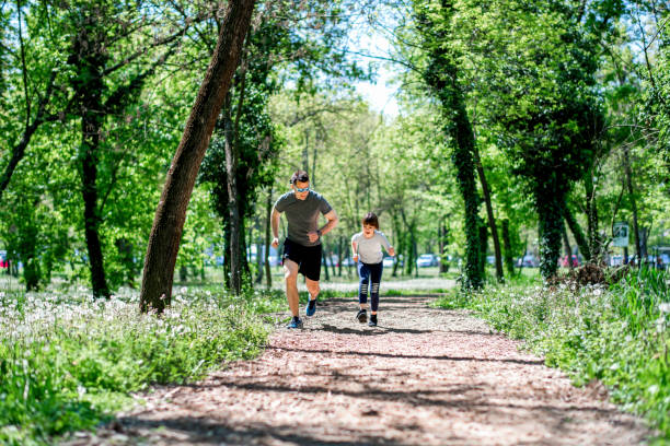 istock Father and daughter running together 1144772556