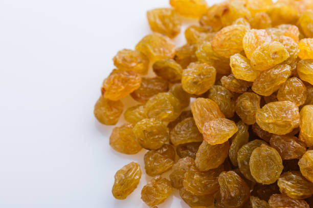 istock golden raisins on a white acrylic background 1144773370