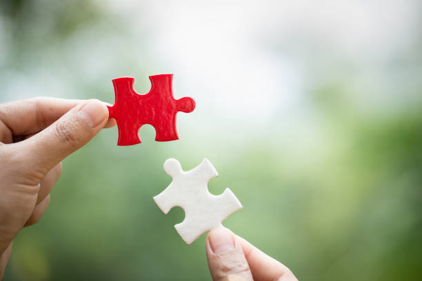 istock Hand connect white and red jigsaw parts with word problem & solution.   symbol of association and connection. business strategy. Teamwork concept. 1144773475
