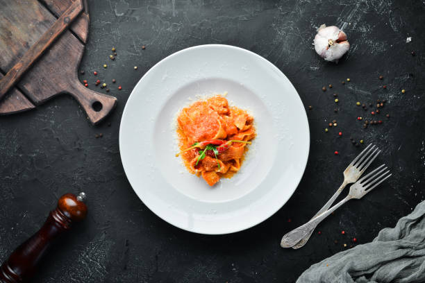 istock Pasta with tomatoes and chili pepper in a plate. Top view. Free space for your text. 1144773586
