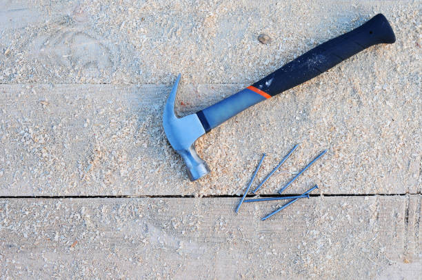 istock Hammer and Nails on Wooden Background. 1144775666