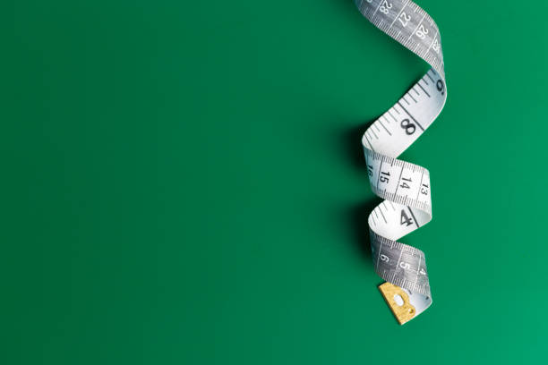 istock measure tape on a green background 1144776397