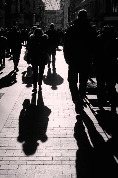 istock People walking on the street. Urban crowd in backlight 1144777532