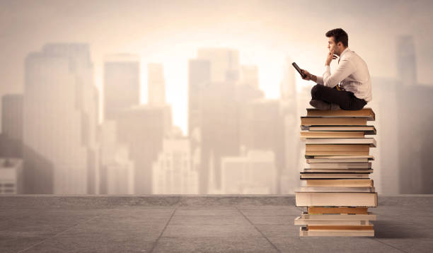 istock Man above the city sitting on books 1144777740
