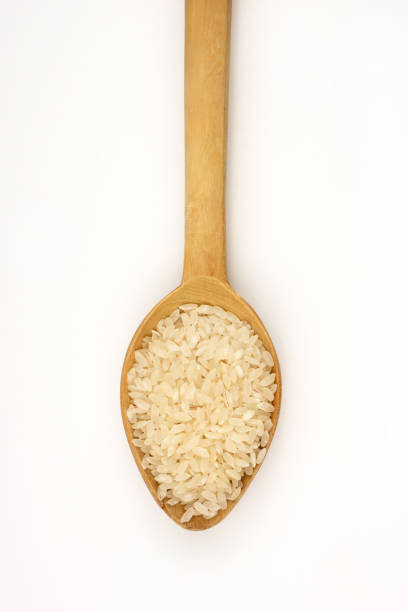 istock Rice in wooden spoon. 1144778302