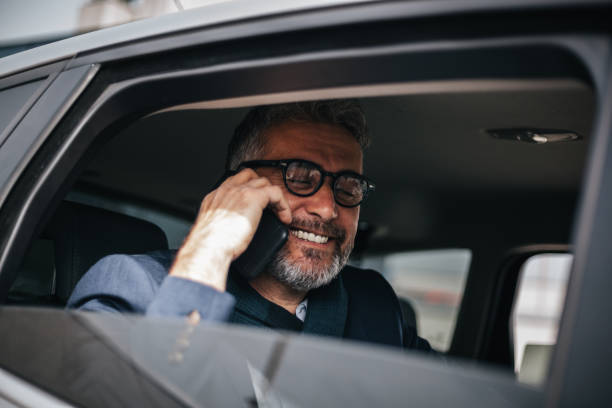 istock Senior businessman using mobile phone in the car 1144782960