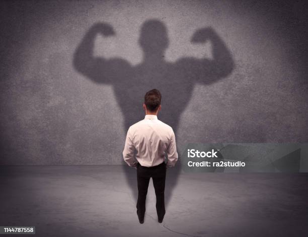 Successful Businessman With Strong Shadow Stock Photo - Download Image Now - Shadow, Muscle, Behind