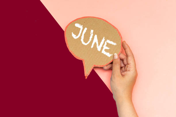 closeup hand holding june speech bubble - white personal organizer calendar speech imagens e fotografias de stock