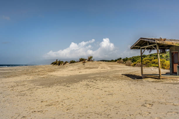 istock Wide sandy beach under blue skies with scattered clouds 1144788688