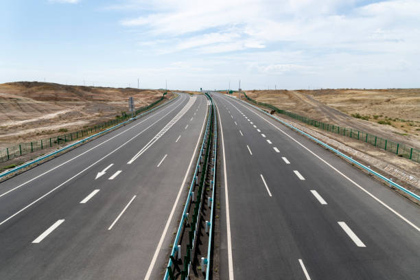 istock Highway perspective in skyline with blue sky and white cloud sky background 1144791172