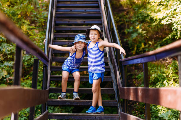istock two boy standing on the stairs 1144791601