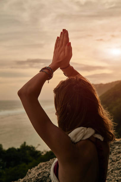 istock Young woman practicing yoga - meditation on the beach. 1144792386