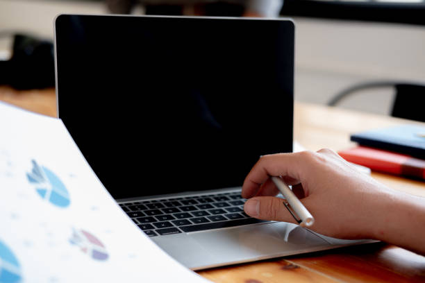 istock Man holding pen in hand and use laptop 1144792756