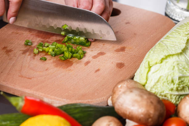 istock young woman slicing herbs in a gray apron 1144792883
