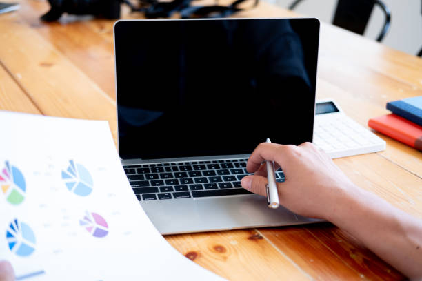 istock Man holding pen in hand and use laptop 1144793006