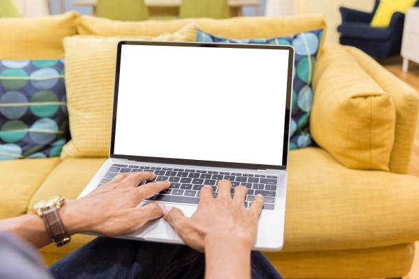 istock Mockup image of a businessman using laptop with blank white desktop screen working in home 1144793308