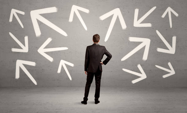 istock Confused salesman with arrows on wall 1144793333