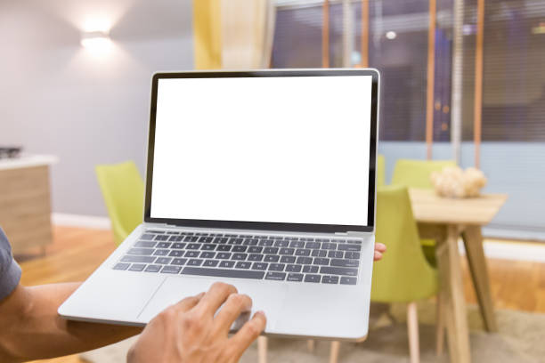 istock Mockup image of a businessman using laptop with blank white desktop screen working in home 1144794592