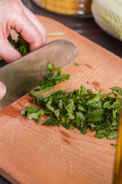 istock young woman slicing herbs in a gray apron 1144794937