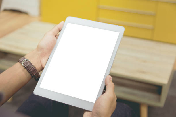 istock Mockup tablet on businessman hands empty display on home table with blur background 1144795038