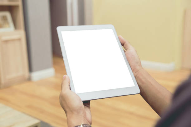 istock Mockup tablet on businessman hands empty display on home table with blur background 1144795042