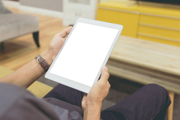 istock Mockup tablet on businessman hands empty display on home table with blur background 1144795044