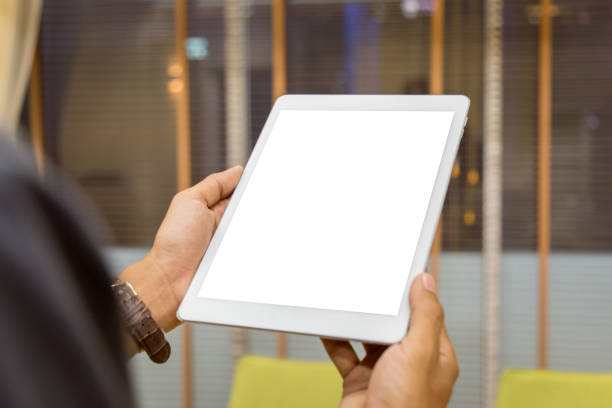 istock Mockup tablet on businessman hands empty display on home table with blur background 1144795067