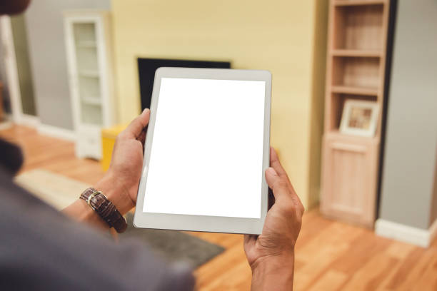 istock Mockup tablet on businessman hands empty display on home table with blur background 1144795155