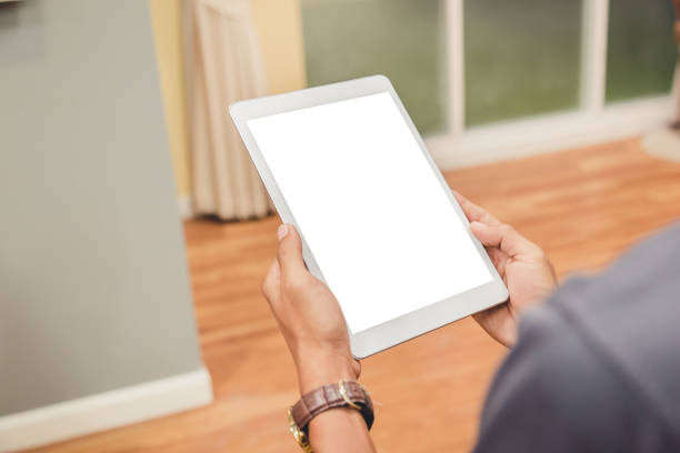 istock Mockup tablet on businessman hands empty display on home table with blur background 1144795180