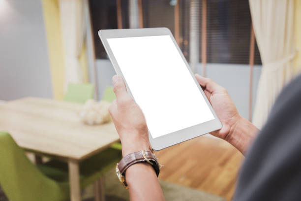 istock Mockup tablet on businessman hands empty display on home table with blur background 1144795345