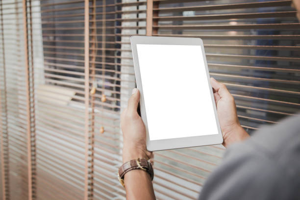 istock Mockup tablet on businessman hands empty display on home table with blur background 1144795405