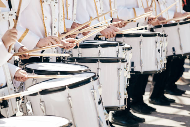 The ensemble of drummers in white ceremonial dress stock photo