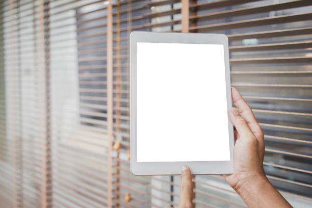 istock Mockup tablet on businessman hands empty display on home table with blur background 1144795442
