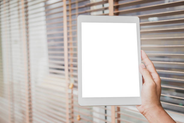 istock Mockup tablet on businessman hands empty display on home table with blur background 1144795448