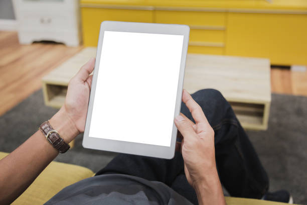 istock Mockup tablet on businessman hands empty display on home table with blur background 1144796124