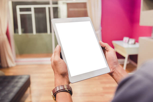 istock Mockup tablet on businessman hands empty display on home table with blur background 1144796133