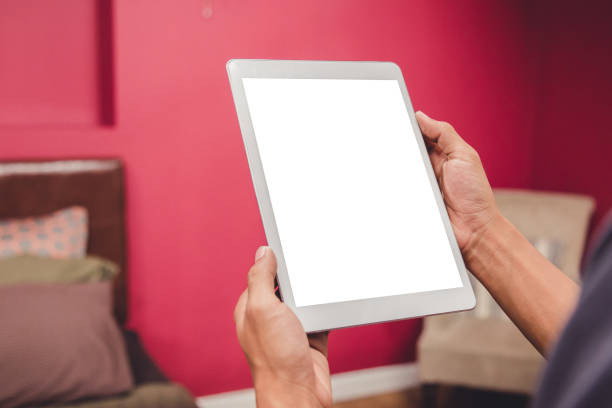 istock Mockup tablet on businessman hands empty display on home table with blur background 1144796236