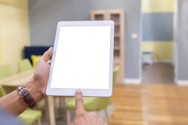 istock Mockup tablet on businessman hands empty display on home table with blur background 1144796318