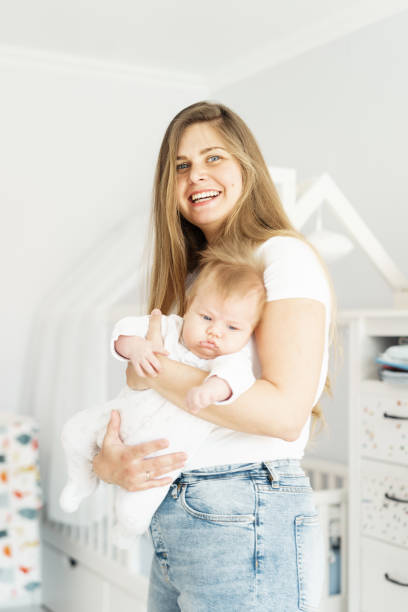 istock Pretty blond long-heared mom and newborn son in her arms 1144798255