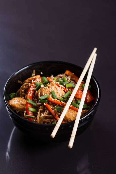 istock Buckwheat noodle in a black bowl on chicken fillet 1144798345