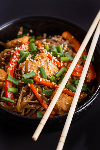 istock Buckwheat noodle in a black bowl on chicken fillet 1144798418