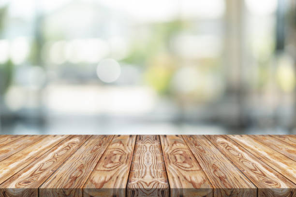istock Empty wood table top on green blur background at shopping mall 1144799349