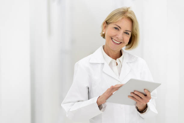 istock Happy dentist at her office looking at the camera smiling 1144800359