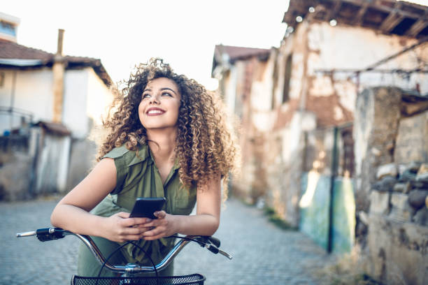istock Female Cyclist Daydreaming And Working On Smartphone 1144801341