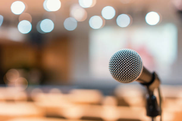 Microphone in meeting room for a conference Microphone in meeting room for a conference. auditorium photos stock pictures, royalty-free photos & images