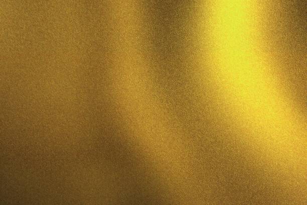 istock Light shining on golden metallic wall in dark room, abstract texture background 1144802189
